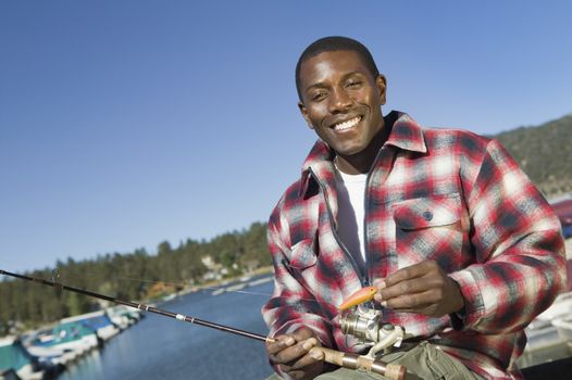 Portrait of an African American man with bait and fishing rod