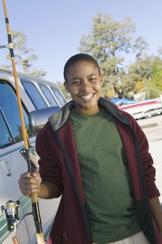 Portrait of happy African American boy with a fishing rod