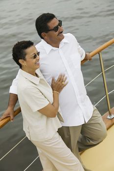 Happy man and woman spending time together on the yacht