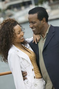 Happy loving African American couple on the yacht