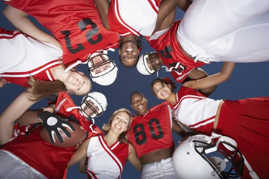 Football Players and cheerleaders in Huddle view from below (view from below)