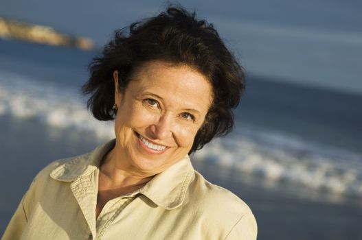 Close-up portrait of a senior woman smiling at beach