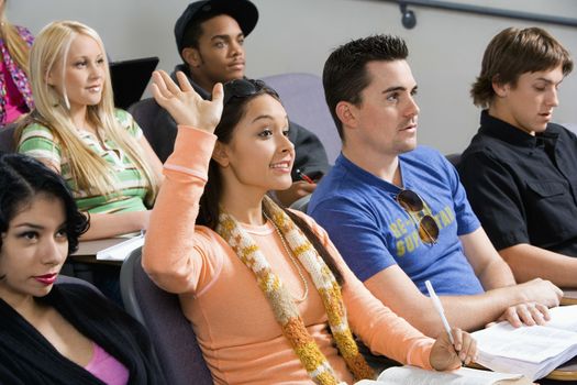Student raising hand during class lecture