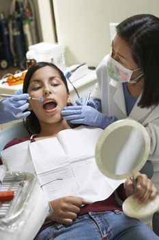 Young female having a dental checkup at clinic