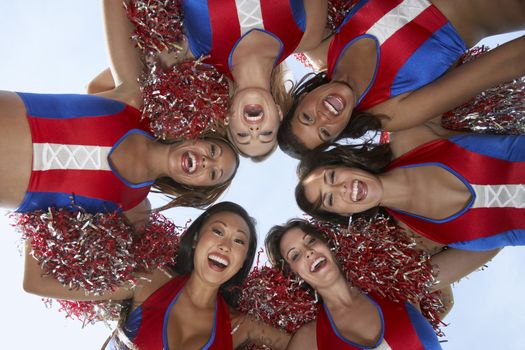 Cheerleaders in a Huddle from below