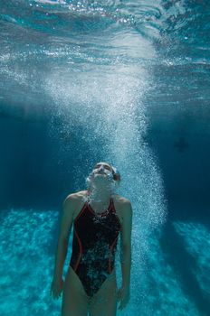 Female swimmer holding breath underwater