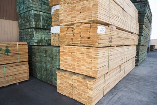 Stack of wooden planks arranged in warehouse
