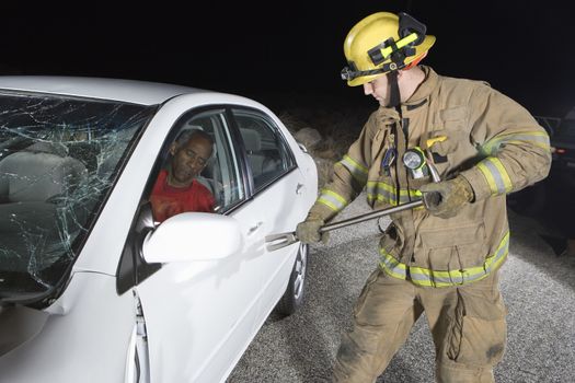 Middle aged male firefighter trying to open car's door