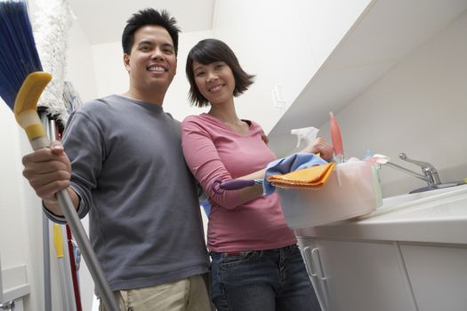 Portrait of happy couple ready to clean the house