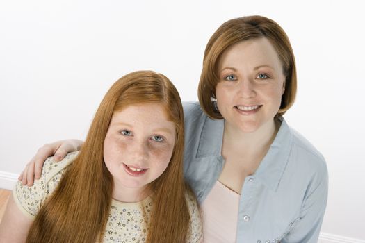Portrait of happy mother and daughter isolated over white background