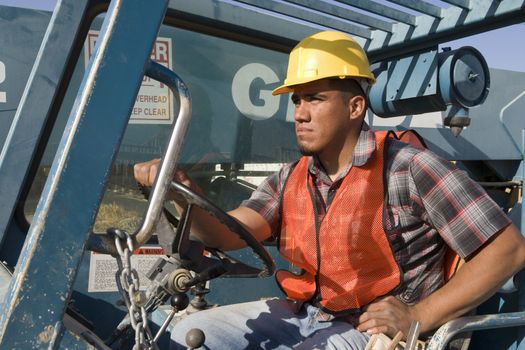 Man driving bulldozer at construction site