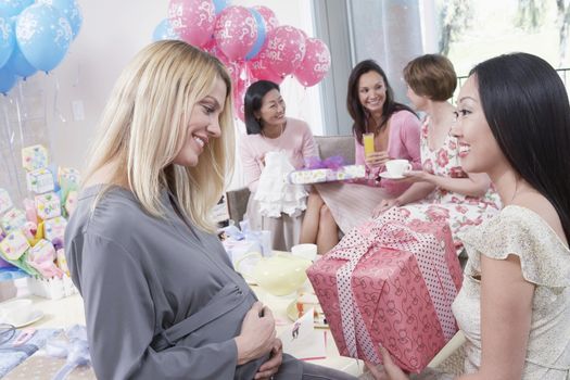 Woman giving gift at baby shower