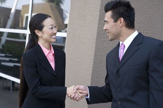 Happy Japanese business people shaking hands