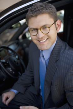 Portrait of happy businessman sitting in car