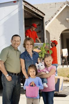 Family in front of removal van and house portrait