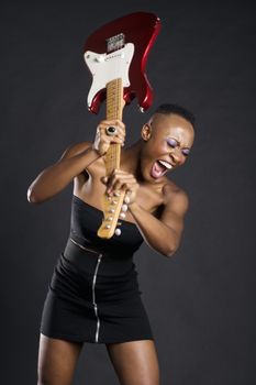 African American woman about to break guitar