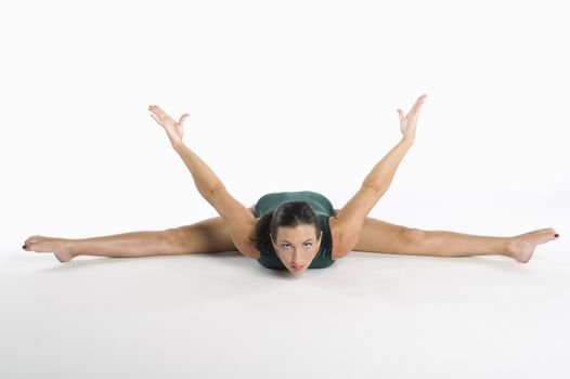 Portrait of mid adult woman exercising over white background