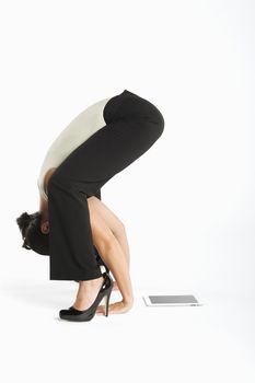Woman exercising with tablet pc on side
