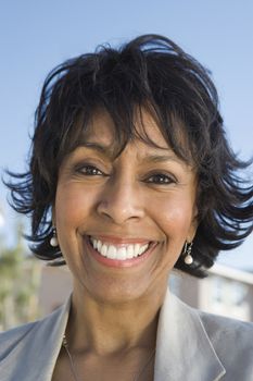 Close-up portrait of happy African American senior woman smiling outdoors