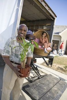 Portrait of happy African American couple moving into a new house