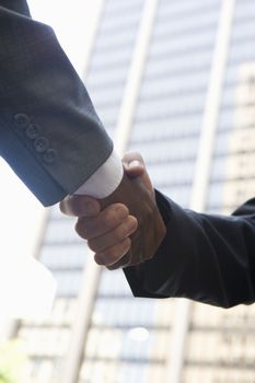 Low angle view of business people shaking hands