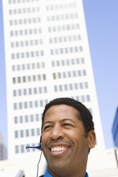 Close up of a happy African American business man with building in the background