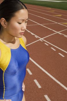Asian female athlete in sportswear on race track