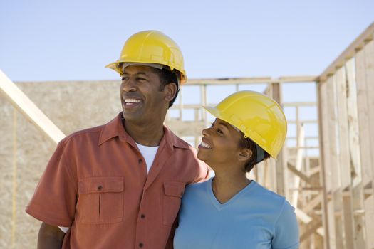 Cheerful African American couple at construction site