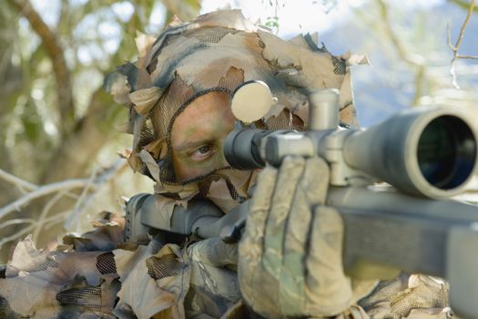 Closeup of soldier aiming through gunsight
