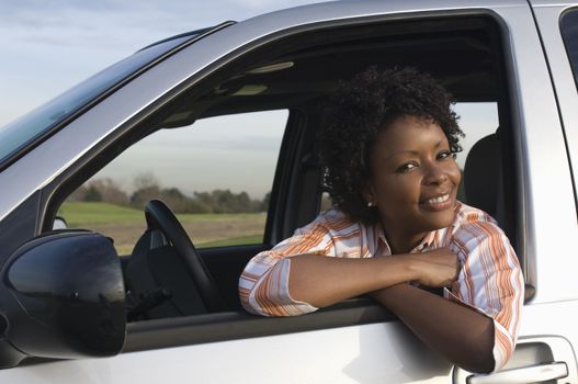 Portrait of mid-adult woman in car window