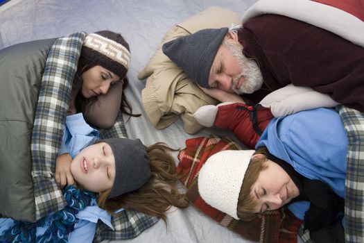 Grandparents and grandchildren sleeping in tent