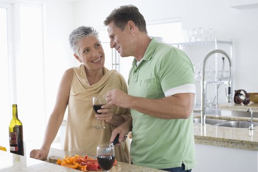 Senior couple communicating with each other while woman holding wine glass