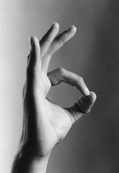 Closeup of a hand gesturing ok sign