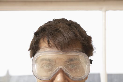 Closeup portrait of man wearing protective eyegoggles
