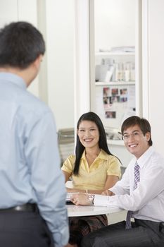 Young Asian business people having discussion in meeting room
