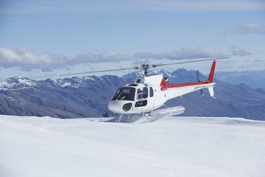 Helicopter Landing On Snowy Mountain Top
