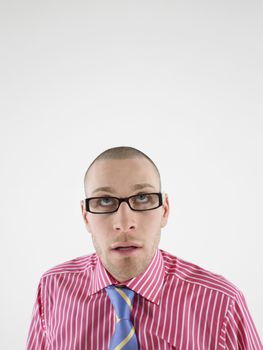 Closeup of a bald man in glasses looking up against white background