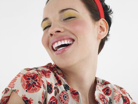 Woman laughing head and shoulders in studio