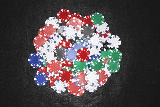 High angle view of colorful gambling chips against black background