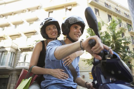 Young Couple Riding Motorscooter