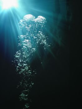 Underwater bubbles and sunlight breaking through