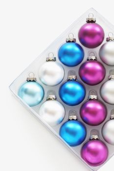 Christmas baubles in tray on white background
