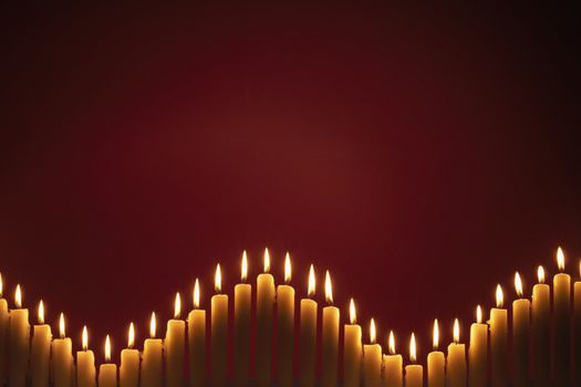 Row of Christmas candles on colored background