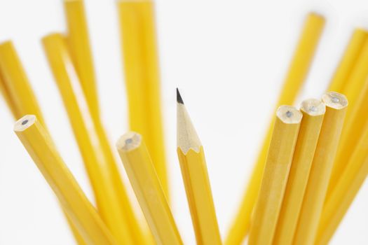 Closeup of yellow pencils over white background