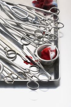 Variety of scissors and medical equipment on tray
