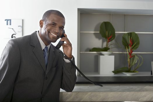 Portrait of a happy African American businessman on call