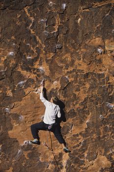 Rock climber climbing cliff