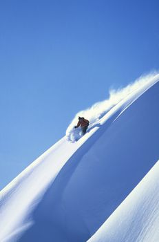 Skier racing down mountain slope