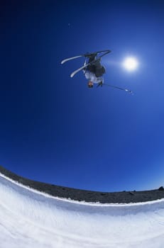 Skier performing flip on mountain