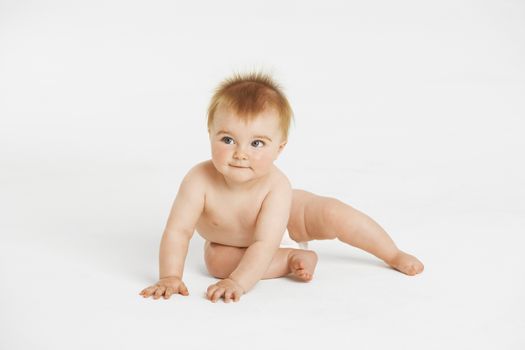 Full length of cute little baby with redhead looking away isolated on white background